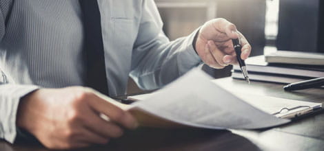 Man looking over documents at a desk